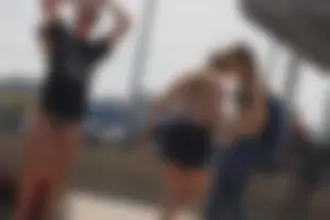 A group of teens in bikinis on the beach