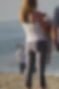 Skinny blonde on the beach in tight grey leggings