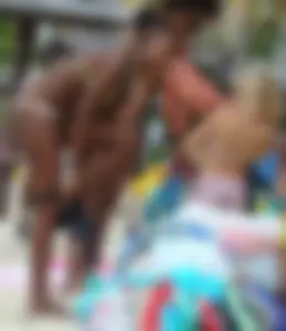 Sexy black babe in various bikinis on the beach while on vacation