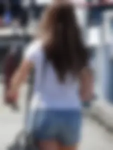 Pretty girl with a camera in little denim shorts
