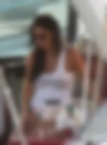 Bikini babe on a boat with a wet see through white shirt showing her tits