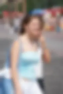 Big boobed girl in blue top with no bra playing in the water