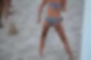 Sexy girl playing beach volleyball in a bikini