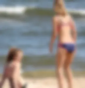 Two sexy beach teens in bikinis, one thick and one skinny with big boobs