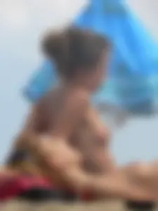 Two topless friends on the beach with nice boobs