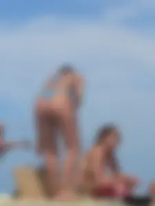 Sexy lady on the beach in a blue thong bikini