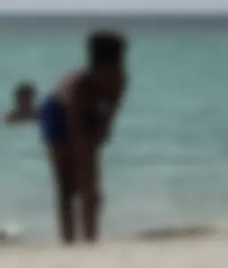 Candid black family, milf and teens on the beach in bikinis