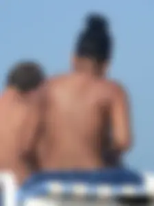 Hot ass topless beach girl with great tits lets her little brother oil up her ass in thong bikini