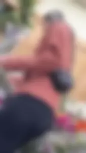 asian round booty looking for flowers at Trader joes