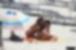 Topless milf and her topless daughter on the beach