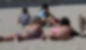 Sexy brunette on the beach in a bikini with great tits