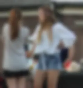 Hippie type dressed girl in denim shorts with a nice ass