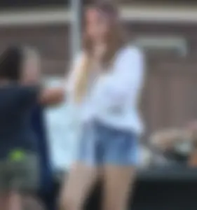 Hippie type dressed girl in denim shorts with a nice ass
