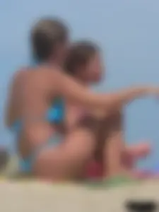 Sexy lady on the beach in a blue thong bikini