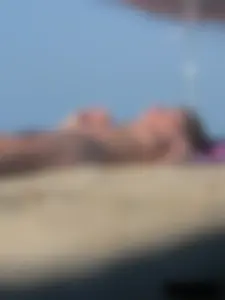 Sexy babe with a nice body topless and in a thong on the beach
