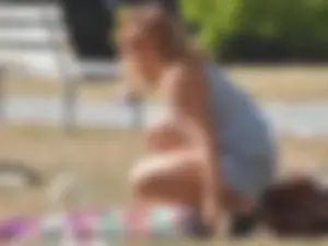 Lady at the park stripping down to her bikini to lay out