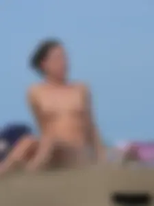 Sexy babe with a nice body topless and in a thong on the beach