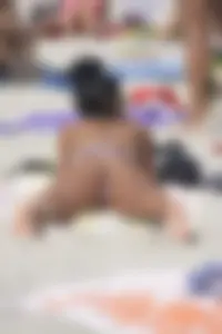 Sexy beach babe in pink bikini makes it a string bikini