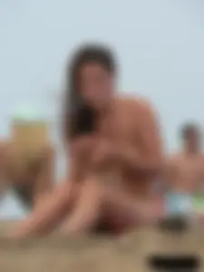 Sexy babe with a nice body topless and in a thong on the beach