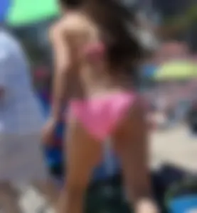 Sexy brunette on the beach in a bikini with great tits