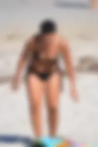 Thick mature brunette bikini lady on the beach with a nice body
