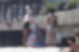 Ashley Tisdale in cheetah print swimsuit on the beach in Malibu
