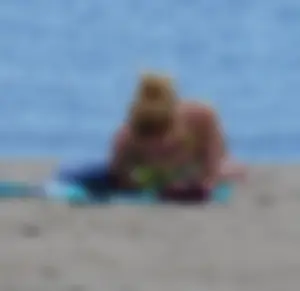 Sexy ass blonde milf on the beach in a thong with cameltoe and bending over