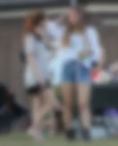 Hippie type dressed girl in denim shorts with a nice ass