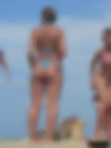 Sexy lady on the beach in a blue thong bikini