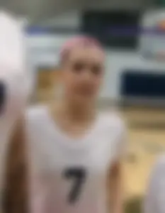Bunch of cute college girls in bright pink shorts playing volleyball