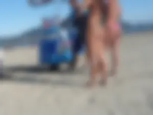 Two tattooed babes on the beach in thong bikinis with nice asses