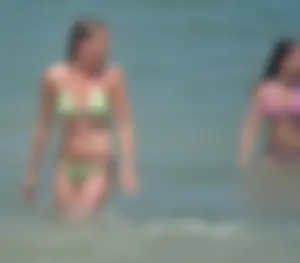 Milf at the beach in the water with hard nipples and a nice body
