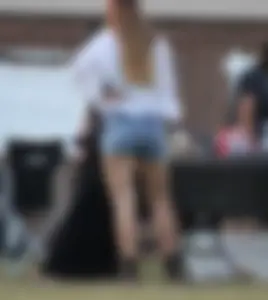 Hippie type dressed girl in denim shorts with a nice ass