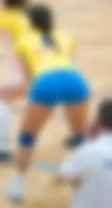 Female Volleyball Player in Blue Spandex Shorts Bend Over Photo