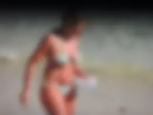 Blonde milf on the beach in her bikini