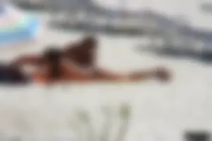 Topless milf and her topless daughter on the beach