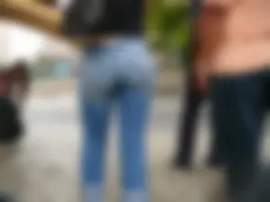 Red haired lady with a nice ass in tight jeans waiting for the bus