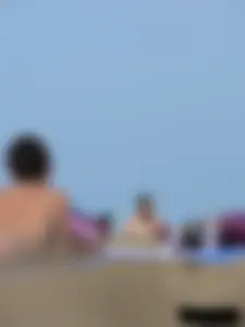 Sexy babe with a nice body topless and in a thong on the beach