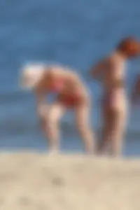 Couple of hot babes hanging out at the beach in bikinis