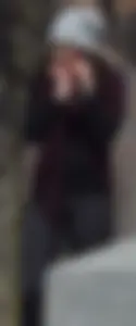 Brunette with glasses on the phone in tight patterned leggings