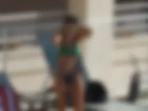 Hot milf sunbathing in a thong by pool and swimming