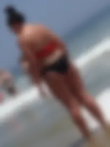 Thick brunette lady on the beach with a big booty