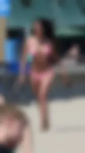 Sexy brunette on the beach in a bikini with great tits