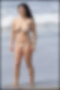 Sexy brunette chick at the beach with big tits and a nice ass in thong bikini