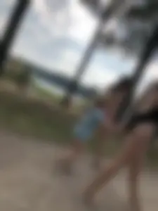 Cute Barefoot Girl in a Black Body Swimsuit Walking on a Road