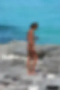 Older lady on a nude beach showing her body