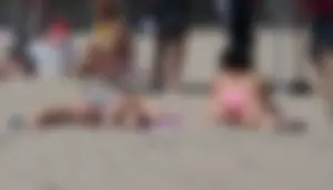 Sexy brunette on the beach in a bikini with great tits