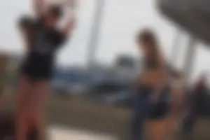 A group of teens in bikinis on the beach