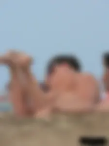 Sexy babe with a nice body topless and in a thong on the beach