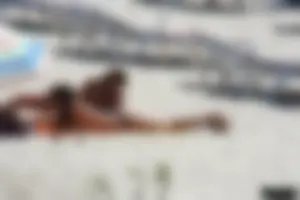 Topless milf and her topless daughter on the beach